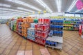 pallets with bottles of colorful soft drinks and beverages for sale in supermarket