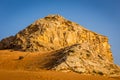 Fossil Rock limestone rock formation in the desert, with sand dunes around, Sharjah, United Arab Emirates Royalty Free Stock Photo