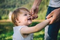 Fother holds his daughter hands , helps her walk Royalty Free Stock Photo