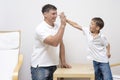 Fother and Son Greets Each Other with High Five Posture Royalty Free Stock Photo