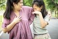 Foul-smelling woman was hug her daughter while her child girl closing nose and can smell the armpit smelly or the body odor foul Royalty Free Stock Photo