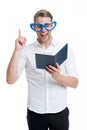 Found answer. Man handsome young pointing upwards and laughing. Man happy face in heart shaped eyeglasses reading book Royalty Free Stock Photo