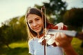 She found her passion at a young age. a young girl playing a violin outdoors. Royalty Free Stock Photo