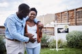 We found a house big enough for our growing family. a young couple standing outside their new home.