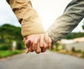 They found love. an unrecognizable couple holding hands outdoors.