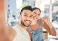 We found a lovely house in a lovely neighbourhood. Portrait of a young couple taking selfies while holding the keys to Royalty Free Stock Photo