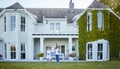 We found our dream home. a young family posing in front of a house with a sold sign. Royalty Free Stock Photo