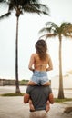 They found their soulmates that summer. Rearview shot of a happy young couple having fun at the beach.