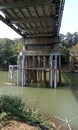 The foundation of the bridge supporting pillars is firmly anchored to the river bed