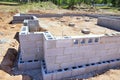 A foundation of cement blocks has been constructed at construction site to support wall of house Royalty Free Stock Photo