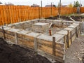 Foundation construction. Concrete is poured into a wooden formwork Royalty Free Stock Photo