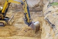 Foundation construction of underground excavator at earthworks on backhoe loader digs Royalty Free Stock Photo