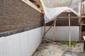 Foundation foam insulation and Damp proofing in problem corner area. House basement, foundation foam insulation details with