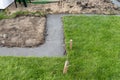 Foundation footings poured in a ditch in the yard, building a terrace in the backyard. Royalty Free Stock Photo