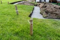 Foundation footings poured in a ditch in the yard, building a terrace in the backyard. Royalty Free Stock Photo