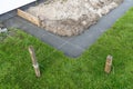 Foundation footings poured in a ditch in the yard, building a terrace in the backyard. Royalty Free Stock Photo