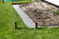 Foundation footings poured in a ditch in the yard, building a terrace in the backyard. Royalty Free Stock Photo