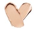 Foundation smears palette close-up. Heart shaped make-up smudge, smear. Cosmetic liquid bb cream beige color smudges Royalty Free Stock Photo