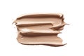 Foundation texture. Beige makeup smudge swatch isolated on white background. Skin tone cosmetic cream strokes