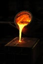 Foundry - molten metal poured from ladle into moul Royalty Free Stock Photo