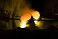 Foundry worker pouring hot molten metal into mold casting Royalty Free Stock Photo