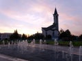 A fountain against the backdrop of a mosque in the rays of the setting sun. Royalty Free Stock Photo