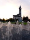 A fountain against the backdrop of a mosque in the rays of the setting sun. Royalty Free Stock Photo