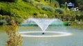 Fountain in the artificial pond Royalty Free Stock Photo