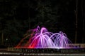 a fountain with a beautiful backlight litm in the park