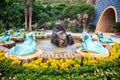 Round Fountain with Blue Frog Sculptures in Park Royalty Free Stock Photo