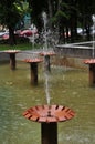 A fountain with bowls from which water flows. City fountain.