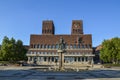 Fountain and bronze statue with women and children in the front of Oslo City Hall