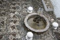 Fountain built with metal water containers in a traditional courtyard in Mostar, Bosnia