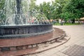 Fountain in city park on summer day. stream of water, drops and bright splashes of water in beautiful city fountain Royalty Free Stock Photo