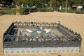 Fountain with colorful tiles and white pigeons who drink in Seville