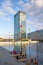 Fountain with colorful windmills and tables at the edges over the skyscrapers at the entrance to the metro in the business