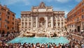 Fountain Di Trevi in Rome, Italy surrounded with tourists during beautiful sunny day