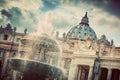 The fountain and the dome of St. Peter's Basilica in Vatican City.