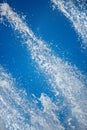 Fountain drops of pure brilliant water against a blue sky