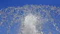 Fountain drops of pure water against a blue sky Royalty Free Stock Photo