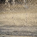 Fountain, drops of water flying in the air. screensaver, background, copy space, texture. light of the sun drops of different