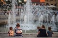 Fountain on Dugonics Ter Square with children playing in front with their grandmothers.