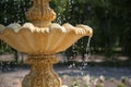 Fountain element close-up. The concept of summer freshness and vacation. Flying drops of water.