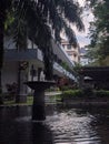 Fountain in the fish pond in a university garden Royalty Free Stock Photo