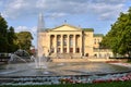 A fountain, flower beds and the facade of the historic opera house Royalty Free Stock Photo