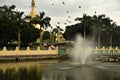 Fountain and Flying Birds close to the Maha Wizaya Pagoda in Yangon Royalty Free Stock Photo