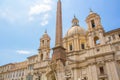 Fountain of the Four Rivers with an Egyptian obelisk and Sant Agnese Church on the famous Piazza Navona Square. Sunny summer day. Royalty Free Stock Photo