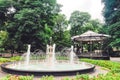 fountain and gazebo in a park with flower beds. Royalty Free Stock Photo