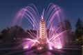 Fountain `Golden Ear` `Golden Ear` in pink lighting on the territory of the All-Russian Exhibition Center VDNH in the even