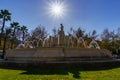 fountain with jets of water in a park of the city of Seville, rays of sun in blue sky without clouds Royalty Free Stock Photo